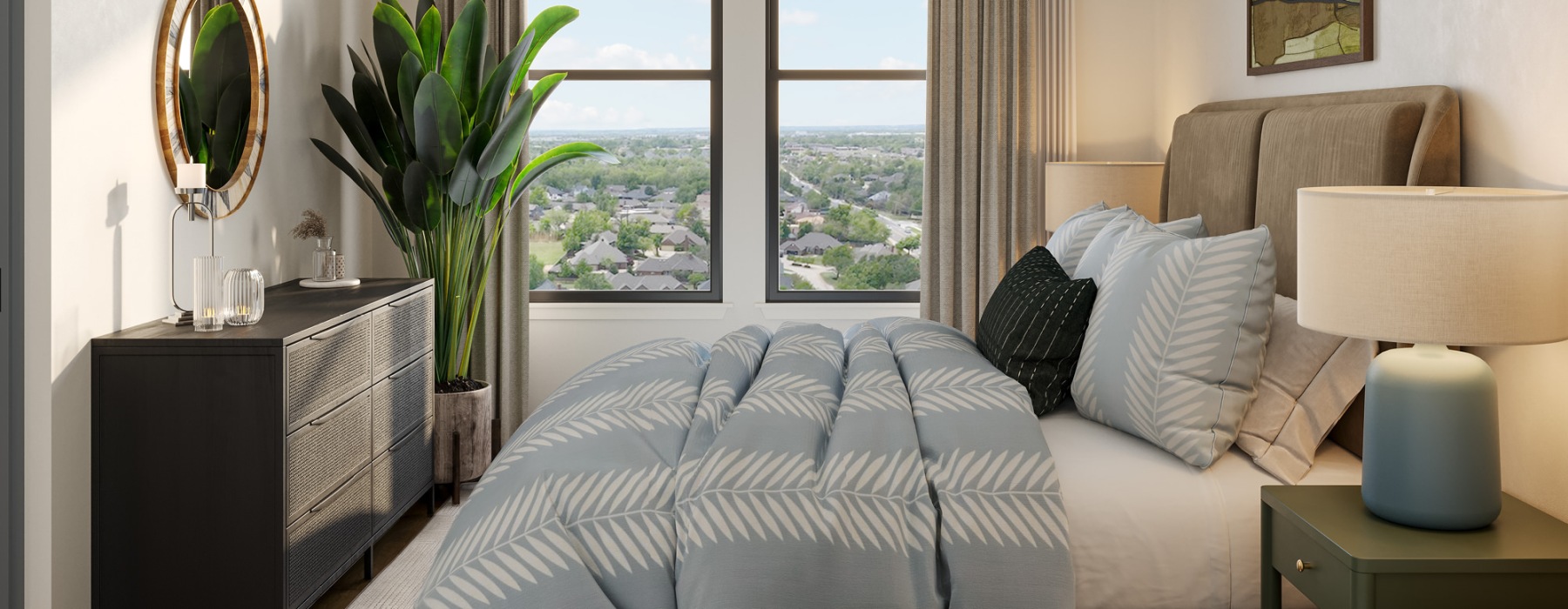 A modern bedroom in one of Oklahoma City's stylish apartments features a double bed with patterned bedding, a bedside lamp, a potted plant, and a dresser adorned with decorations. The large window offers a charming view of the suburban neighborhood.